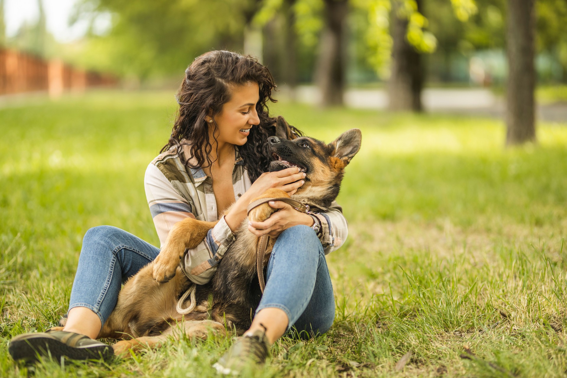 Woman playing with her dog at the park Woman playing with her dog at the park